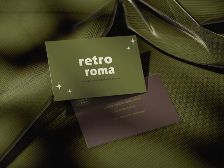 An image featuring two business cards for "Retro Roma," a thrift shop based in Milan, set against a backdrop of draped, olive-green textured fabric.